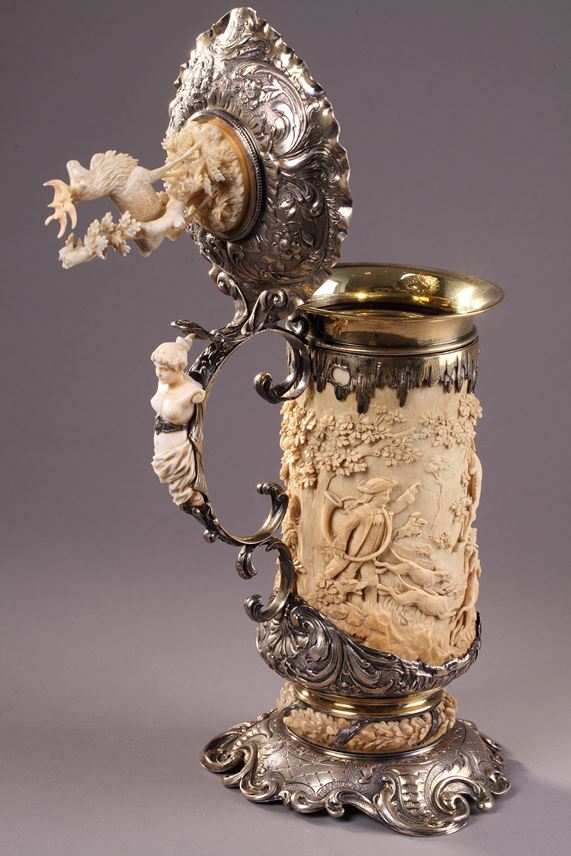 A SILVER MOUNTED RELIEF CARVED IVORY TANKARD | MasterArt